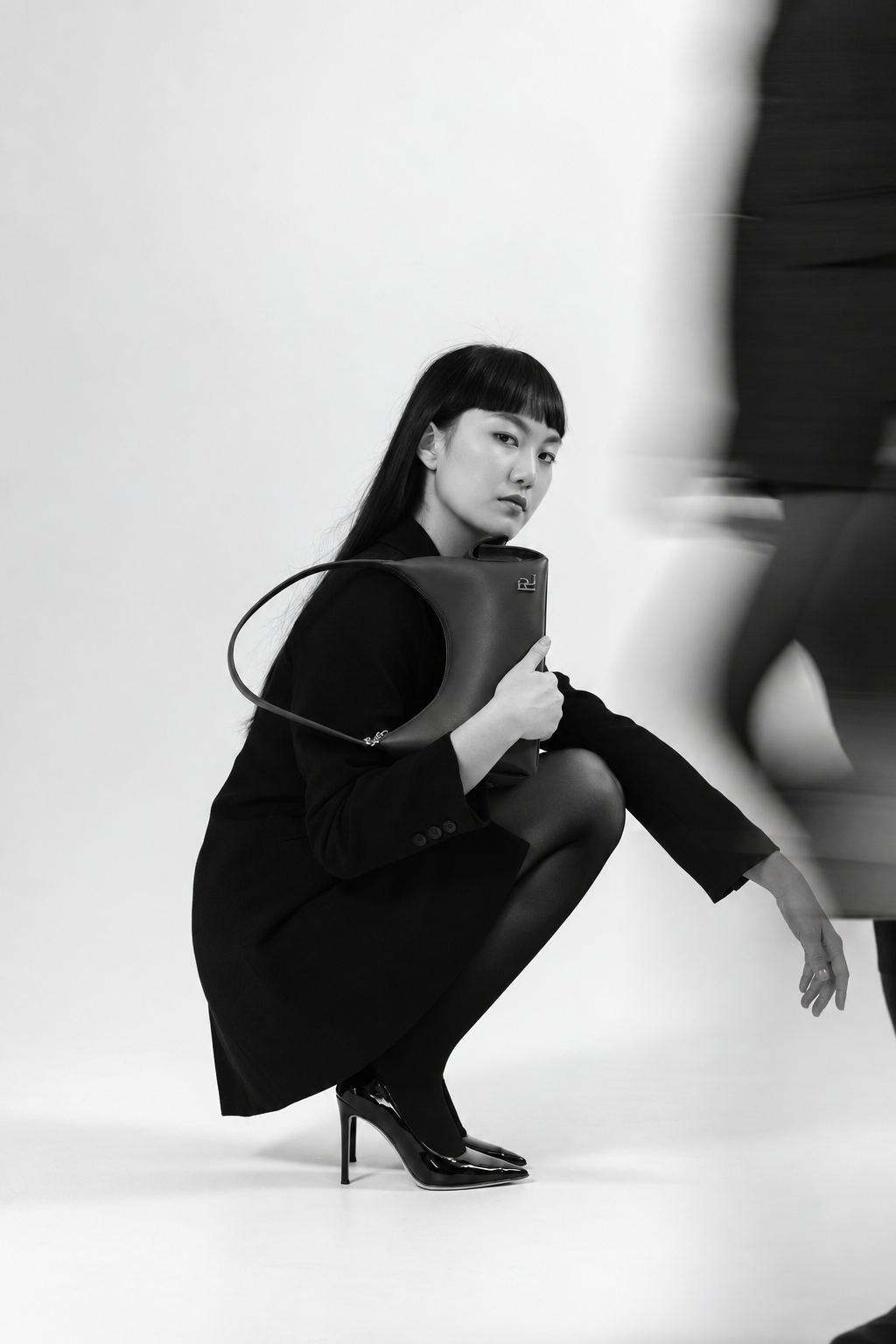 RLYN campaign model carrying a handbag
