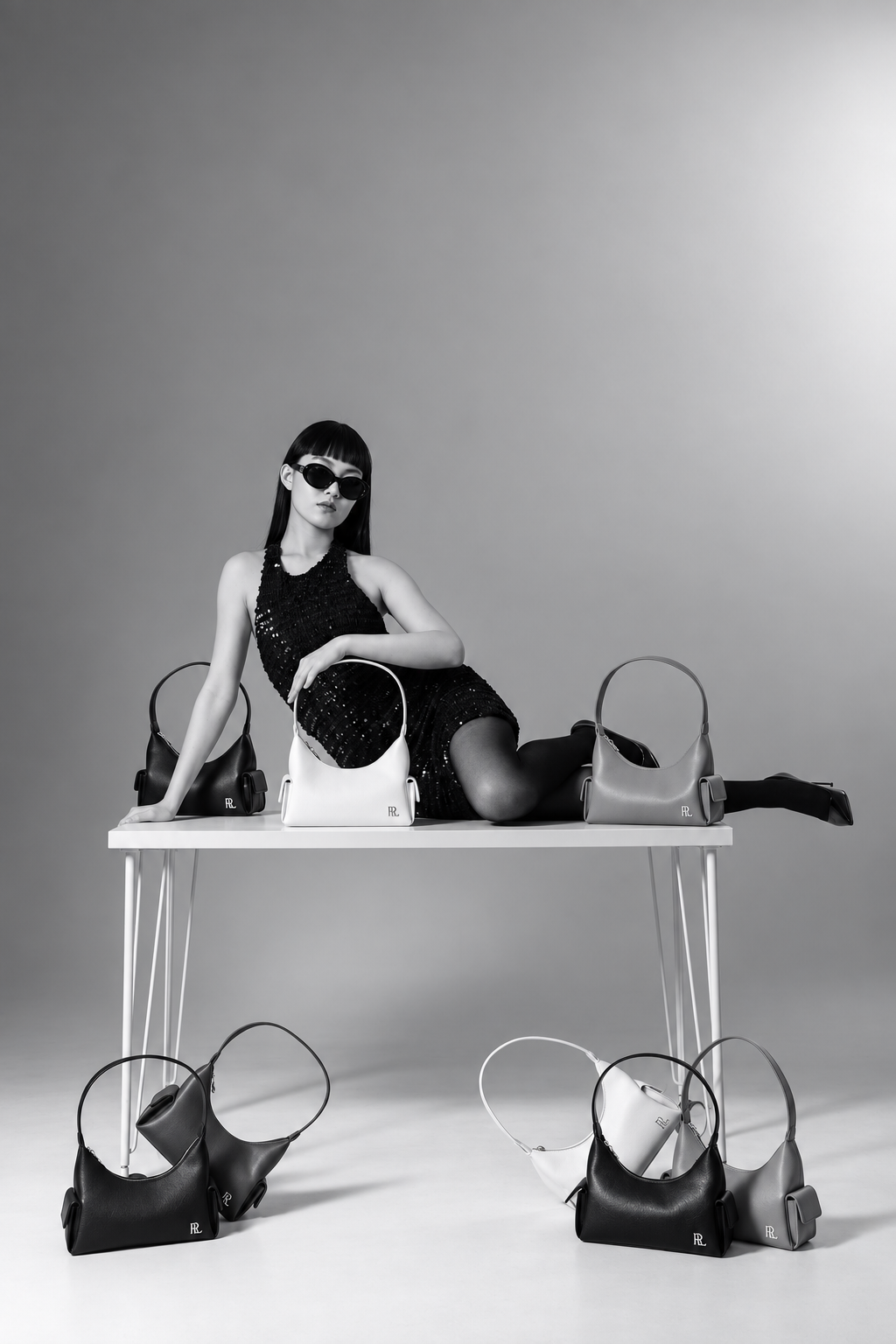 RLYN campaign model surrounded by handbags
